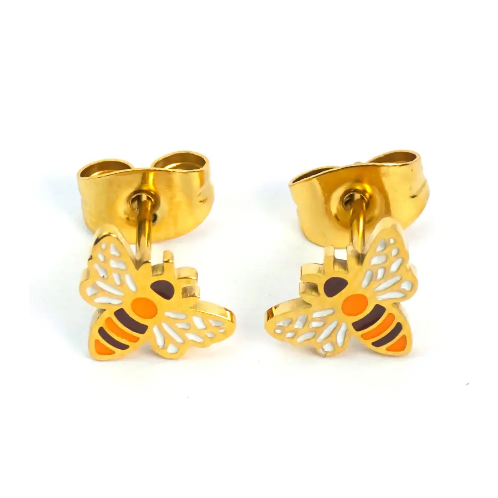 Gold bee stud earrings by Michelle Stephen with orange, white, and black enamel detailing, displayed with butterfly backings on gold-plated posts.