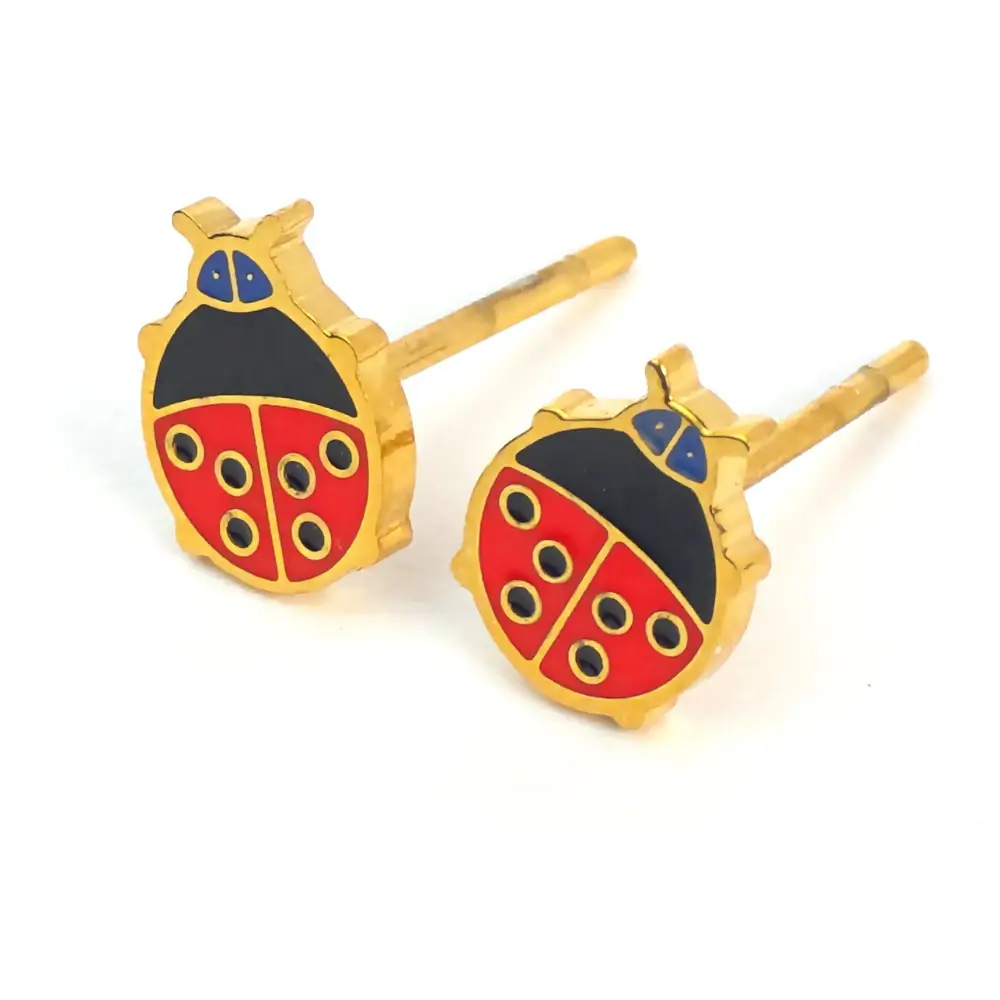 Gold ladybug earrings with red wings and black spots.
