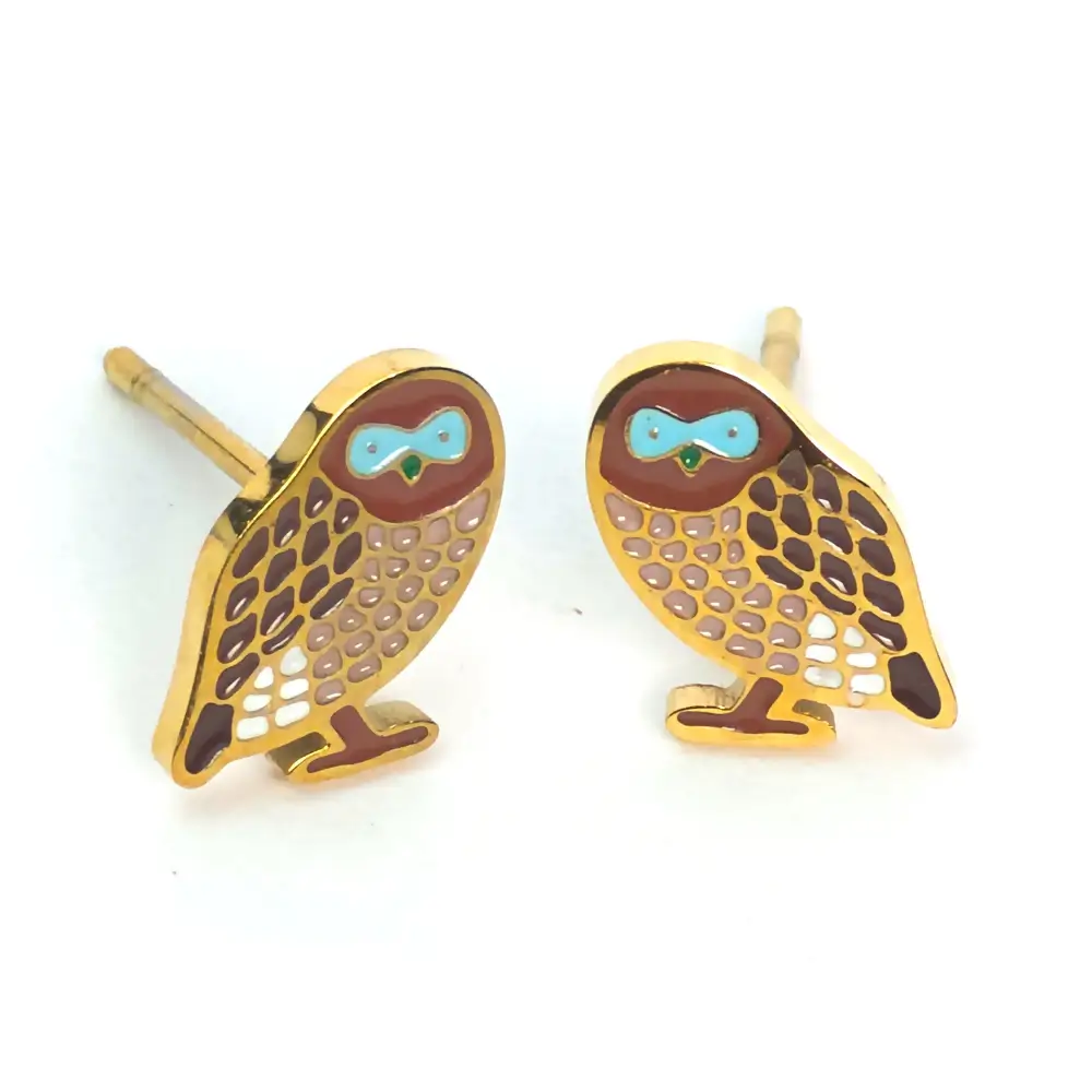 Gold owl earrings with brown feathers and blue eyes.