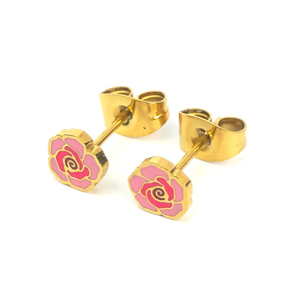 Pair of small stud earrings shaped like roses, with gold-tone metal outlines and pink enamel petals. The earrings are displayed at an angle, showing the posts and butterfly backings.